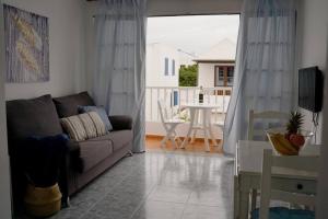 a living room with a couch and a table at Apartamento Alisio in Arrieta