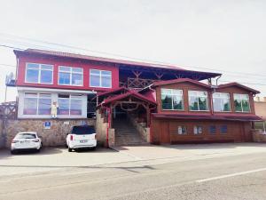 a house with a car parked in front of it at Restaurant and Pension Stenly in Spišský Štvrtok