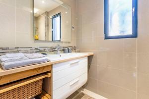 a bathroom with a sink and a mirror at Le Chalet des Fanières in Chartres