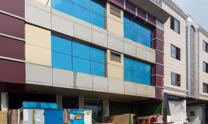 an exterior view of a building with blue windows at Hotel Pacific Blu in Lucknow