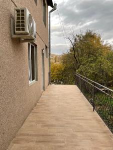 a walkway leading to a building with an air conditioner at Dream Home in Vanadzor