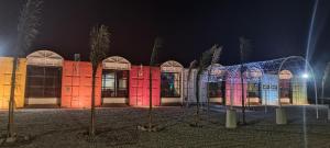 a building with a lit up facade at night at Hotel en Ruta in Fiambalá
