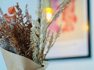 a bouquet of dried flowers in a paper vase at The Old Hotel Silkeborg - S1 in Silkeborg
