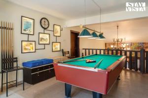 a living room with a pool table in it at StayVista's Grace & Light - Hill-view villa with Outdoor pool, Terrace & Games room in Panchgani