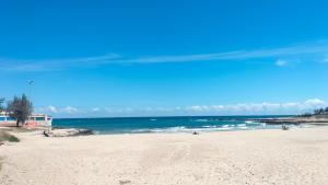a sandy beach with the ocean in the background at Flore's House Ostuni in Villanova di Ostuni