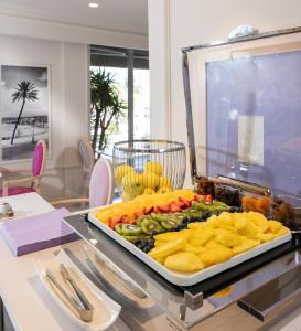 a tray of fruit and vegetables on a table at Hotel Suisse in Nice