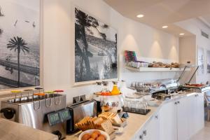 a kitchen with a counter with food on it at Hotel Suisse in Nice