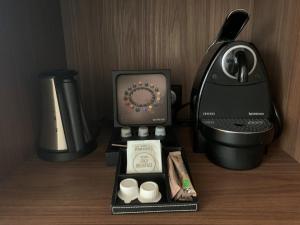 a hotel room with a coffee maker and a coffee machine at Best Western Plus Metz Technopole in Metz