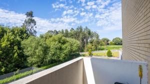 a view from the balcony of a house with trees at Seaside Retreat T2 by LovelyStay in Arcozelo