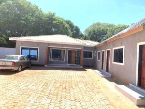 a house with a car parked in front of it at Radiant lodge in Lusaka