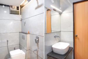 a bathroom with a toilet and a sink and a shower at FabHotel Lotus Blue in Bhopal