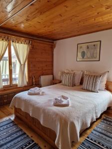 ein Schlafzimmer mit einem großen Bett mit zwei Handtüchern darauf in der Unterkunft Casa Tisaru in Lepşa
