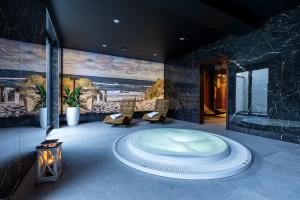 a bathroom with a large tub in the middle at BELMAR Park Resort in Władysławowo +79 photos