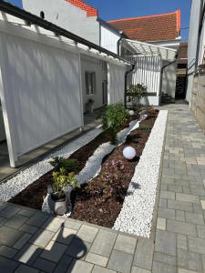a garden with rocks and plants in front of a house at Aparthouse in Lugoj