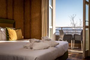 a hotel room with a bed with towels on it at Piajo Relax Hotel in Nembro