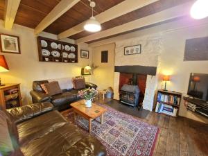 a living room with a couch and a fireplace at Arwel Nanternis in Llanllwchaiarn