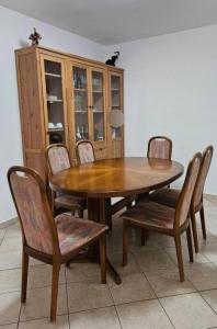 a dining room table and chairs with a wooden table and cabinets at La Glorie/ The Glory/ La Gloria in Pully