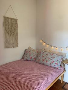 a bedroom with a bed with a red and white comforter at La stanza di Campagna in Campiglia Marittima