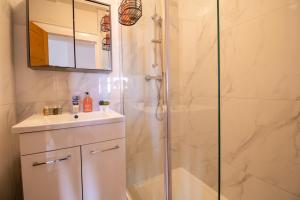 a bathroom with a shower and a sink at Luxurious Apartments on Oxford Street in London