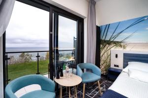 Posteľ alebo postele v izbe v ubytovaní Hotel Faleza - z widokiem na morze