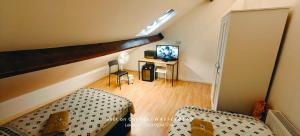 a living room with a couch and a desk with a television at St Lucia women only lodge Leicester long stays in Leicester