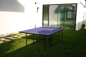 a ping pong table on the grass in front of a house at Ashta Gold Suite in Fethiye