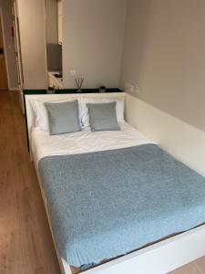 a bed with two pillows on it in a room at The Depot in Bath in Bath