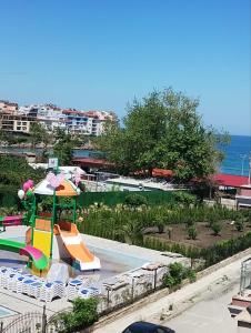 a pool with a slide and a playground at Sozopol Harmani Beach Apartment 10 in Sozopol