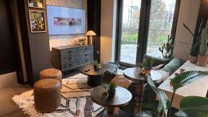 a living room with a couch and tables and a tv at The Depot in Bath in Bath