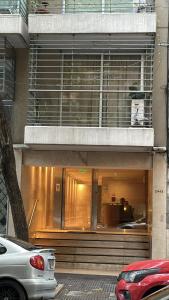 a store front of a building with cars parked in front at 2 ambientes moderno y muy bien ubicado in Buenos Aires