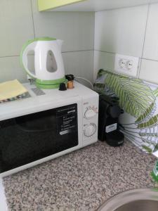 a microwave sitting on top of a counter at Apartments Ella in Rovinj
