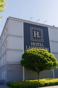 a building with a sign that reads hotel lamination at Hotel Lamberton in Ołtarzew +90 photos