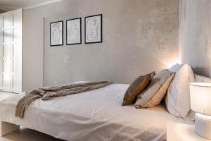 a bedroom with a white bed with pillows on it at SPACIOUS & quiet Apt - Old Town & Kazimierz in Krakow
