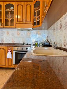 a kitchen with a sink and a stove at Levi's Villa Radhima in Vlorë