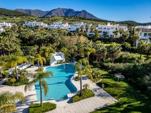 an aerial view of a resort with a swimming pool and palm trees at Paradise Lagoon Alcazaba by Domvia in Estepona