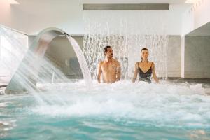 a man and a woman standing in a water fountain at Arrecife Gran Hotel & Spa in Arrecife