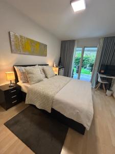 a bedroom with a large bed and a sliding glass door at Daianas Corner in Elgg