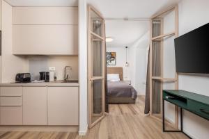 a kitchen and a bedroom with a bed in a room at Apartment Wow in Rijeka