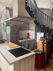 a kitchen with a stove and a counter top at Grand appartement 2 à 8 personnes in Cauterets