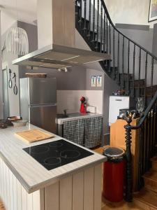 a kitchen with a stove and a counter top at Grand appartement 2 à 8 personnes in Cauterets +8 photos