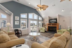 a living room with a couch and a fireplace at SH450 Sea You Soon in Southern Shores