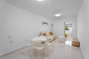 a white living room with a white table and chairs at Costa del Silencio Tenerife Sur in Arona