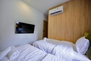 a hotel room with two beds and a tv at 3 Bed 3 Bath / Luxury / 1 min walk to BTS Asok in Bangkok