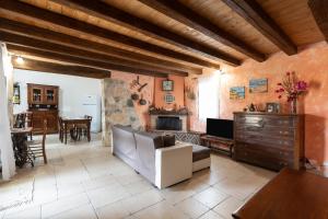 a living room with a couch and a fireplace at Villa Siciliana con piscina privata in Buseto Palizzolo