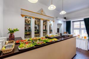 a buffet with many plates of food on a counter at Hotel Bristol in Kielce