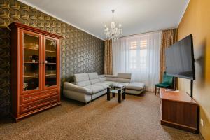 a living room with a couch and a flat screen tv at Hotel Bristol in Kielce +37 photos