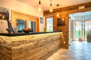 a bar in a kitchen with wooden walls at Hotel Appartement Haus Gitschberg in Vandoies