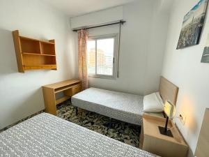 Postel nebo postele na pokoji v ubytování Apartamentos Gandia-Daimuz 3000