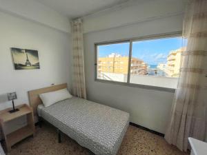 Postel nebo postele na pokoji v ubytování Apartamentos Gandia-Daimuz 3000