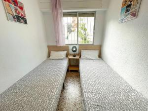 Postel nebo postele na pokoji v ubytování Apartamentos Gandia-Daimuz 3000